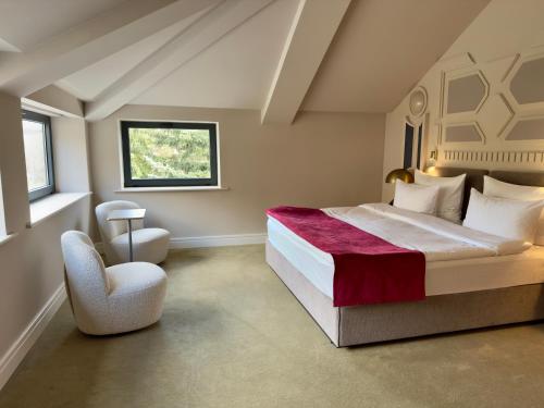 a bedroom with a large bed and a chair at Moselle Armenia Wellness & Medical SPA Jermuk in Jermuk
