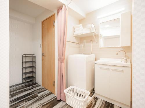 a small kitchen with a sink and a refrigerator at Vacation Inn Omorikaigan 1 in Tokyo