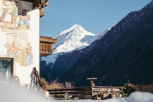 a building with a snow covered mountain in the background at HoferVals in Valles
