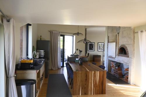 a kitchen with a table and a fireplace at Skaam Cabin Luxe Hideaway with a Naughty Side in Wolseley