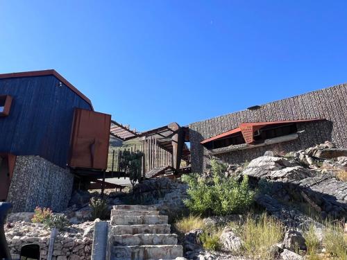 a building with a staircase next to a house at Skaam Cabin Luxe Hideaway with a Naughty Side in Wolseley