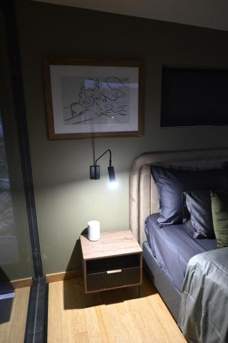 a bedroom with a bed and a nightstand next to a table at Skaam Cabin Luxe Hideaway with a Naughty Side in Wolseley