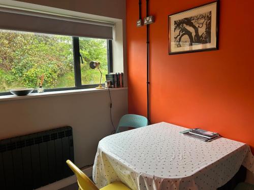 a dining room with a table and a window at Peaceful space in Llanbedrog in Llanbedrog