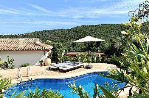 a villa with a swimming pool and a mountain at Villa Marlena, Calonge, Costa Brava,1 luxe private studio-appartement with private pool in quiet area, adults only, Catalonia, Spain in Calonge
