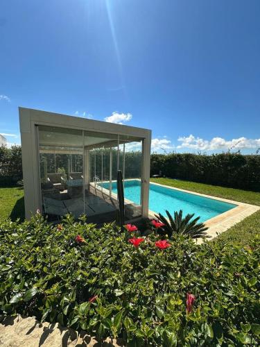 a house with a swimming pool and a garden at Daijobu in Tangier Relax in Exclusive Pool in Tangier