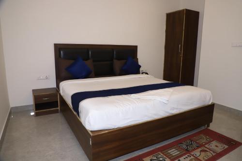 a bedroom with a large bed with blue pillows at Hotel Akash Inn Agra I 200 m From Taj Mahal in Agra