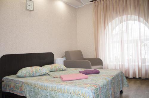 a bedroom with a bed with two towels on it at Studio in the city center metro Historical Museum in Kharkiv