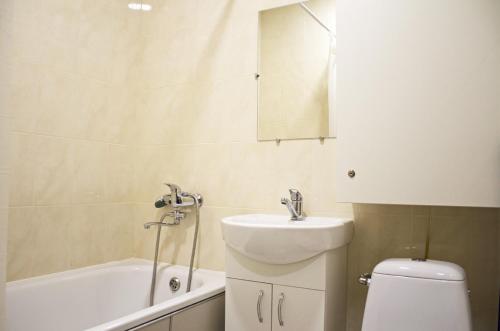 a bathroom with a sink and a toilet and a bath tub at Studio in the city center metro Historical Museum in Kharkiv