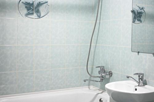 a bathroom with a sink and a bath tub at Studio in the city center metro Historical Museum in Kharkiv