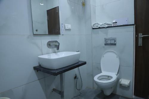 a bathroom with a sink and a toilet at Hotel Akash Inn Agra I 200 m From Taj Mahal in Agra