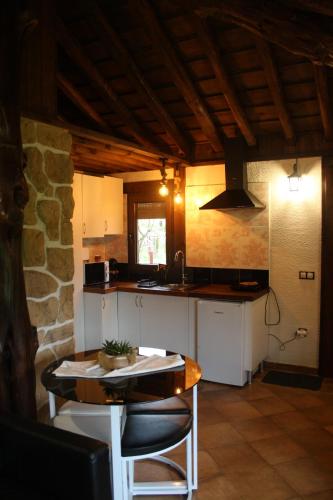 a kitchen with a table and a counter top at El BURGO DE OSMA ALOJAMIENTO RURAL VILLA BAGH in El Burgo de Osma