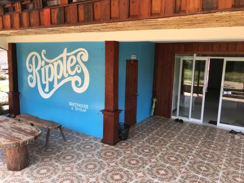 a blue wall with a pirates sign on it at Ripples Guesthouse and Sky Bar in Koh Rong Sanloem