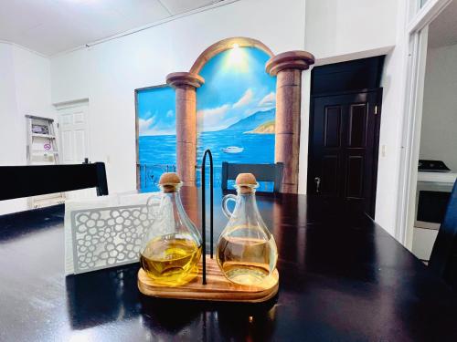 a table with two glass bottles of whiskey on it at San Francisco Luxury Prestige 3 in Juticalpa