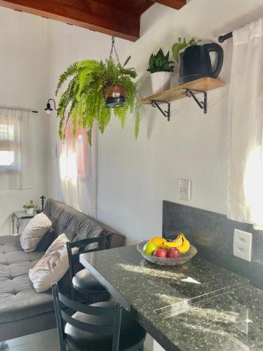 a kitchen with a table with a bowl of fruit on it at Chale aconchegante da ilha in Florianópolis