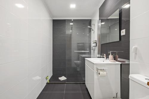 a bathroom with a shower and a toilet and a sink at Funchal Ocean Terrace APT in Funchal