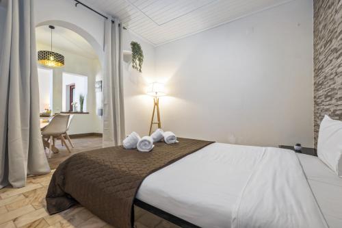 a bedroom with a large bed with towels on it at Funchal Ocean Terrace APT in Funchal