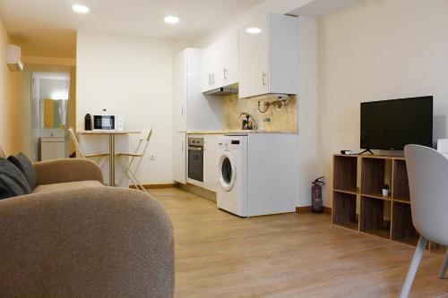 a living room with a kitchen with a washing machine at Rampa 24 in Vila Real