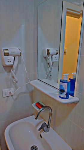 a bathroom with a sink and a mirror at Hotel Room in Aqua Palms Hurghada in Hurghada