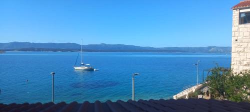 a sailboat in the middle of a large body of water at Studio Sea view in Bol
