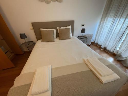 a bedroom with a large bed with two towels on it at Riverside Expo in Lisbon