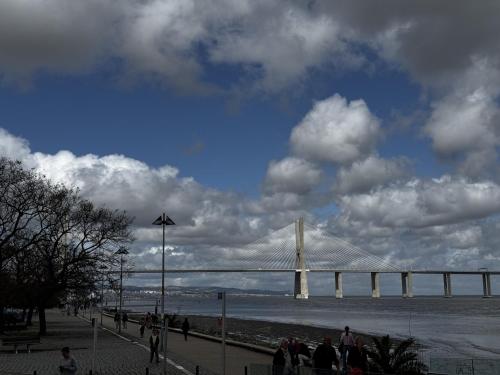 a bridge over a body of water with people walking at Riverside Expo in Lisbon