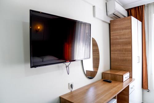 a flat screen tv hanging on a wall at LAOS OTEL in Istanbul