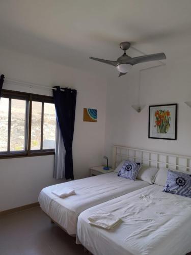 a bedroom with a bed and a ceiling fan at Arenas Blancas 203 in La Restinga
