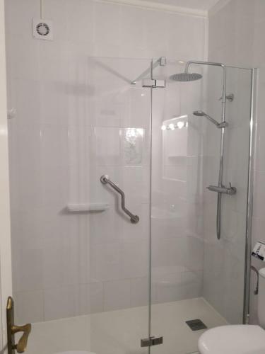 a shower with a glass door in a bathroom at Arenas Blancas 203 in La Restinga