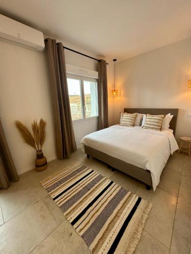 a bedroom with a large bed and a window at 27 côté remparts in Aigues-Mortes