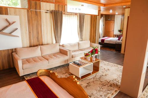 a living room with a couch and a table at Mountain BNB Hartola in Rāmgarh