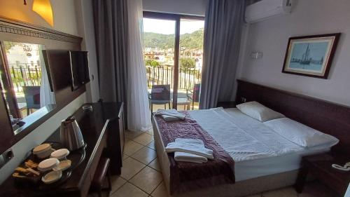 a hotel room with a bed and a balcony at Club Viva Hotel in Marmaris