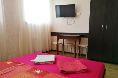 a room with a table with a tv and towels at Studio in the city center metro Historical Museum in Kharkiv