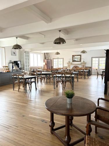 an empty room with tables and chairs and a kitchen at Hotel D'Angleterre in Roscoff