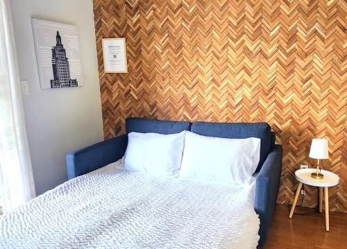 a blue bed with white pillows in a bedroom at Jennifer's Walkable Private Apartment Getaway with Relaxing Deck in Providence