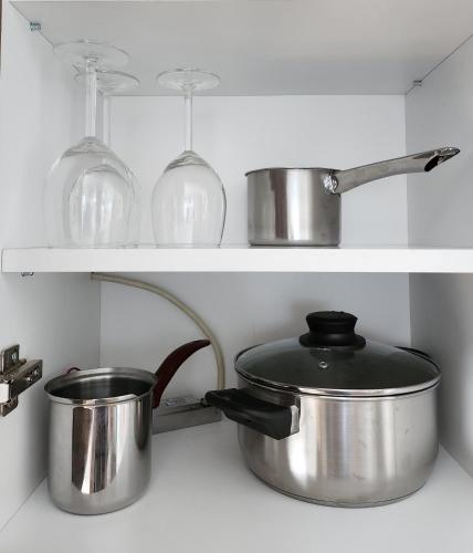 a kitchen with pots and pans on a shelf at Apartment Endorfin - Modern apartment close to airport in Surčin
