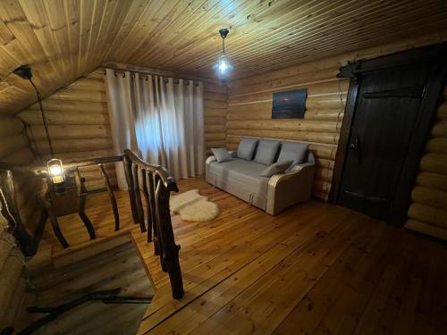 a living room with a couch and a table at Gostynna sadyba Kit Bayun in Teterivka