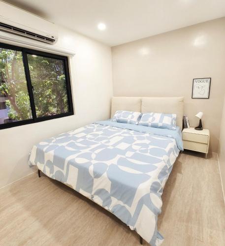 a bedroom with a large bed with a window at Kiddie Hostel 13A2-kids and pets friendly in Kababae