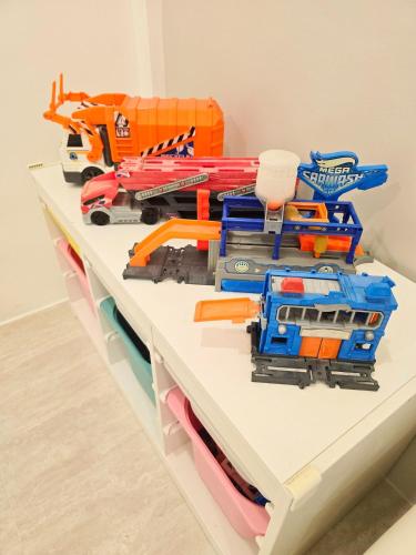 a shelf with a bunch of toy trains on it at Kiddie Hostel 13A2-kids and pets friendly in Kababae