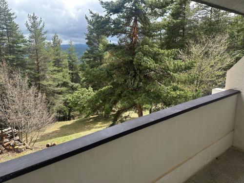 a balcony with a view of a tree at Парк-хотел Родопи in Churen