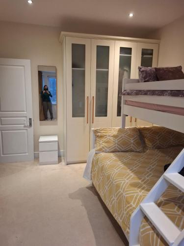 a person taking a picture of a bedroom with a bunk bed at Quiet & Bright Room in Malahide