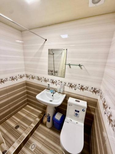 a bathroom with a toilet and a sink at Yusuf Gold House in Samarkand