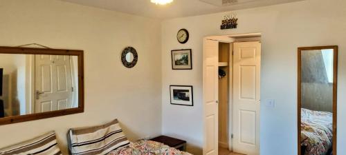 a bedroom with a mirror and a bed and a mirror at Your 4 Bedroom Townhouse - Superking Bed in Stamford