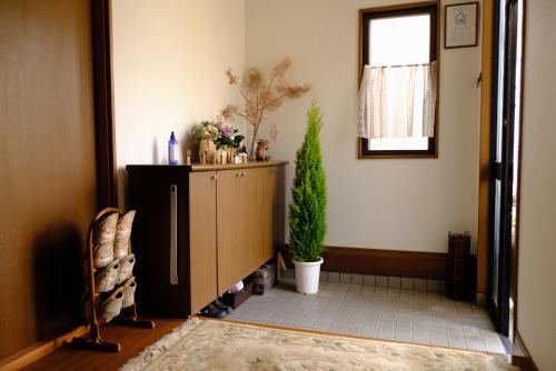 a living room with a tv and a plant at Minpaku-K in Nasushiobara