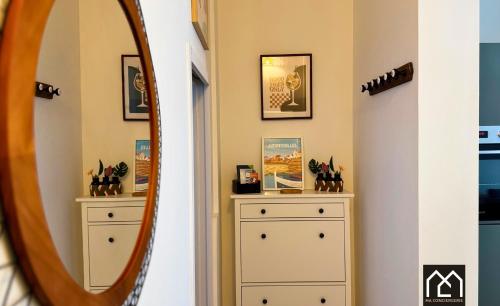 a hallway with two dressers and a mirror at Ro'Cam Spot - Hyper Centre, Cour, parking in Boulogne-sur-Mer