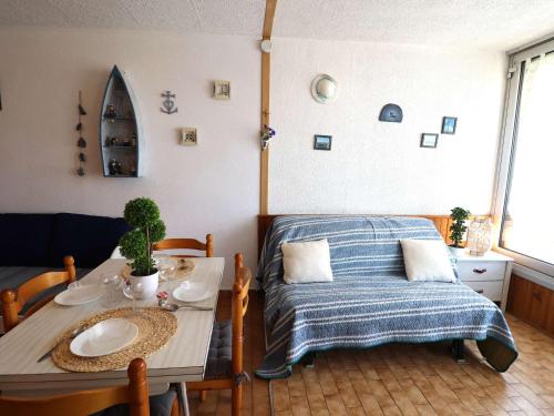 - une chambre avec une table, un lit, une table et des chaises dans l'établissement Studio Cabine avec Piscines, Parking, Proche Mer et Commerces - FR-1-307-61, au Grau-du-Roi
