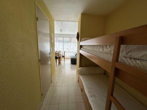 - un couloir avec 2 lits superposés dans une chambre dans l'établissement Centre-ville, proche plage - Appt 2P cabine, 4 pers avec parking privé, Le Grau-du-Roi - FR-1-250-114, au Grau-du-Roi