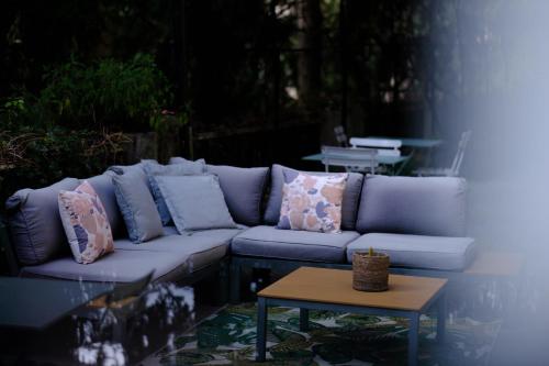 a blue couch with pillows on it next to a table at Le Stanze del Lago Suites & Pool in Como