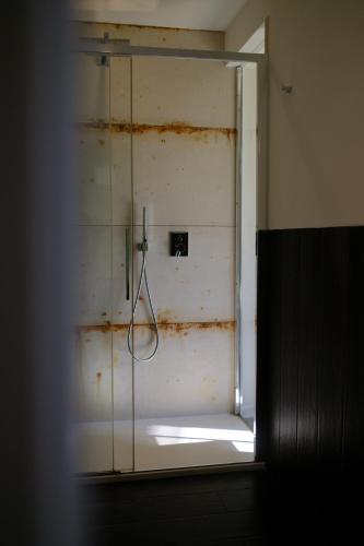 a bathroom with a shower with a glass door at Le Stanze del Lago Suites & Pool in Como