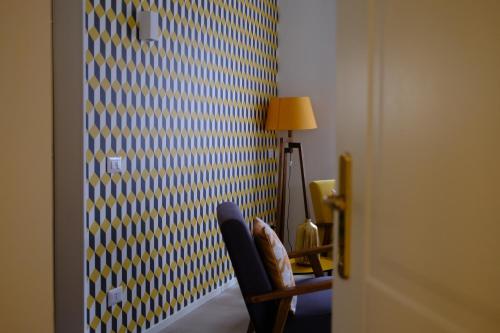 a room with a blue and yellow wall with a chair at Le Stanze del Lago Suites & Pool in Como