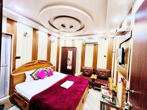 a bedroom with a bed and a couch and a tv at Ssexotica in Patna